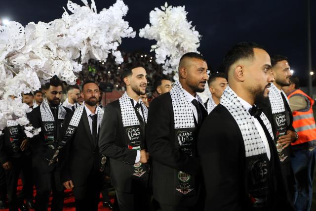 (260927) -- HEBRON, Sept. 27, 2026 (Xinhua) -- Grooms attend a mass wedding ceremony in Dura near the West Bank city of Hebron, on Sept. 26, 2026. The mass wedding ceremony brought together 88 Palestinian grooms and brides, with thousands of local residents attending the event. (Photo by Mamoun Wazwaz/Xinhua)