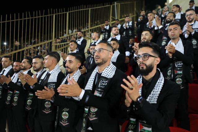 (260927) -- HEBRON, Sept. 27, 2026 (Xinhua) -- Grooms attend a mass wedding ceremony in Dura near the West Bank city of Hebron, on Sept. 26, 2026. The mass wedding ceremony brought together 88 Palestinian grooms and brides, with thousands of local residents attending the event. (Photo by Mamoun Wazwaz/Xinhua)