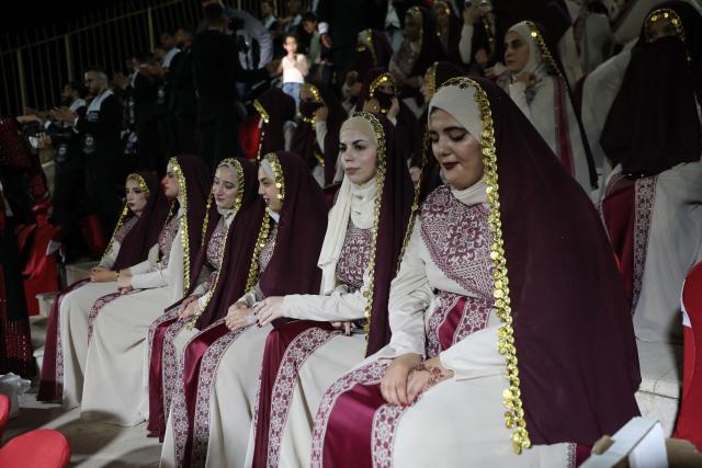 (260927) -- HEBRON, Sept. 27, 2026 (Xinhua) -- Brides attend a mass wedding ceremony in Dura near the West Bank city of Hebron, on Sept. 26, 2026. The mass wedding ceremony brought together 88 Palestinian grooms and brides, with thousands of local residents attending the event. (Photo by Mamoun Wazwaz/Xinhua)