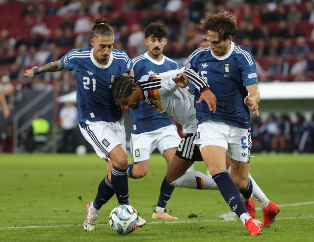 (260928) -- AUGSBURG, Sept. 28, 2026 (Xinhua) -- Kevin Schade (2nd R) of Germany vies with Panagiotis Retsos (1st R) and Kostas Tsimikas (1st L) of Greece during the UEFA Nations League 2026/27 League A Group A match between Germany and Greece in Augsburg, Germany, Sept. 27, 2026. (Photo by Philippe Ruiz/Xinhua)