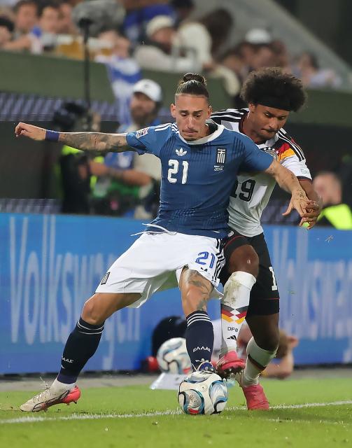(260928) -- AUGSBURG, Sept. 28, 2026 (Xinhua) -- Karim Adeyem (R) of Germany vies with Kostas Tsimikas of Greece during the UEFA Nations League 2026/27 League A Group A match between Germany and Greece in Augsburg, Germany, Sept. 27, 2026. (Photo by Philippe Ruiz/Xinhua)