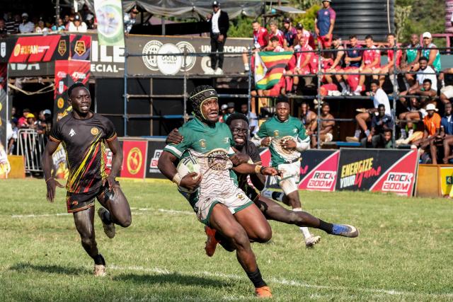 (260928) -- KAMPALA, Sept. 28, 2026 (Xinhua) -- Players of Uganda and Zimbabwe compete for the ball during the 2026 Rugby Africa Men's Sevens Series final match between Uganda and Zimbabwe in Kampala, Uganda, on Sept. 27, 2026. (Photo by Hajarah Nalwadda/Xinhua)