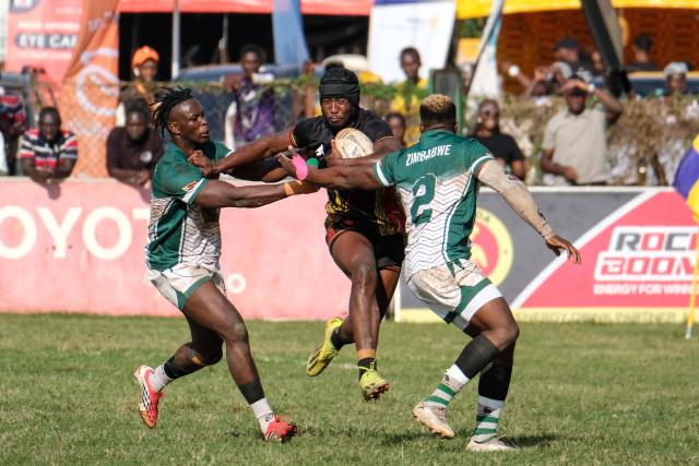 (260928) -- KAMPALA, Sept. 28, 2026 (Xinhua) -- Desire Ayera (C) of Uganda competes for the ball during the 2026 Rugby Africa Men's Sevens Series final match between Uganda and Zimbabwe in Kampala, Uganda, on Sept. 27, 2026. (Photo by Hajarah Nalwadda/Xinhua)