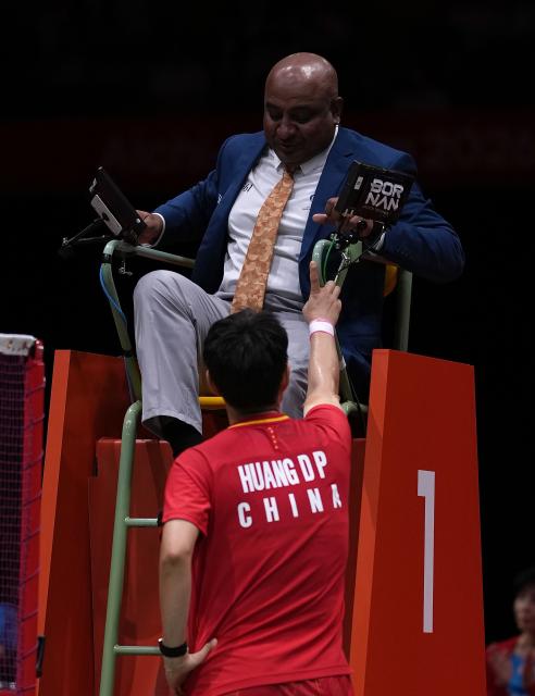 (260928) -- ICHINOMIYA, Sept. 28, 2026 (Xinhua) -- Huang Dongping (bottom) of China gestures as she talks with an umpire after the mixed doubles semifinals of badminton between Feng Yanzhe/Huang Dongping of China and Amri Syahnawi/Nita Violina Marwah of Indonesia at the 20th Asian Games Aichi-Nagoya 2026 in Ichinomiya of Aichi Prefecture, Japan, Sept. 28, 2026. (Xinhua/Li Bo)