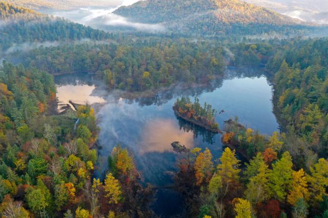 (260928) -- HARBIN, Sept. 28, 2026 (Xinhua) -- An aerial drone photo taken on Sept. 27, 2026 shows the scenery of Jingpo Lake scenic area in Mudanjiang City, northeast China's Heilongjiang Province. In autumn, Heilongjiang Province is filled with vibrant colors. Mountains, forests and waters form a picturesque landscape, showcasing the beauty of autumn in northeastern China. (Photo by Wang Zhe/Xinhua)