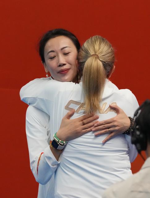 (260928) -- SHIZUOKA, Sept. 28, 2026 (Xinhua) -- China's coach Zhang Xiaohuan (L) and Ana Tarres hug each other after the mixed team free routine of artistic swimming at the 20th Asian Games Aichi-Nagoya 2026 in Shizuoka, Japan, Sept. 28, 2026. (Xinhua/Zhou Mi)