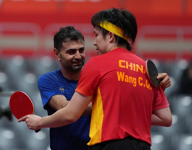 (260928) -- TOYOTA, Sept. 28, 2026 (Xinhua) -- Noshad Alamiyan (L) of Iran and Wang Chuqin of China greet each other after the men's singles semifinals of table tennis at the 20th Asian Games Aichi-Nagoya 2026 in Toyota of Aichi Prefecture, Japan, Sept. 28, 2026. (Xinhua/Wang Fei)