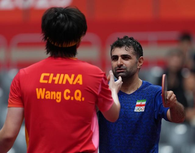(260928) -- TOYOTA, Sept. 28, 2026 (Xinhua) -- Noshad Alamiyan (R) of Iran and Wang Chuqin of China greet each other after the men's singles semifinals of table tennis at the 20th Asian Games Aichi-Nagoya 2026 in Toyota of Aichi Prefecture, Japan, Sept. 28, 2026. (Xinhua/Wang Fei)
