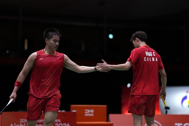 (260928) -- ICHINOMIYA, Sept. 28, 2026 (Xinhua) -- Liang Weikeng (L)/Wang Chang of China celebrate during the men's doubles semifinals of badminton against Fajar Alfian/Muhammad Shohibul Fikri of Indonesia at the 20th Asian Games Aichi-Nagoya 2026 in Ichinomiya of Aichi Prefecture, Japan, Sept. 28, 2026. (Xinhua/Li Bo)