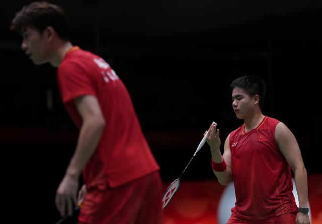 (260928) -- ICHINOMIYA, Sept. 28, 2026 (Xinhua) -- Liang Weikeng (R)/Wang Chang of China react during the men's doubles semifinals of badminton against Fajar Alfian/Muhammad Shohibul Fikri of Indonesia at the 20th Asian Games Aichi-Nagoya 2026 in Ichinomiya of Aichi Prefecture, Japan, Sept. 28, 2026. (Xinhua/Li Bo)