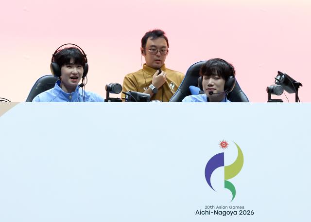 (260928) -- TOKONAME, Sept. 28, 2026 (Xinhua) -- Xu Bicheng (L) and Huang Yaoqin (R) of team China react after the Honor of Kings final of Esports between team China and team Malaysia at the 20th Asian Games Aichi-Nagoya 2026 in Tokoname of Aichi Prefecture, Japan, Sept. 28, 2026. (Xinhua/Yao Qilin)