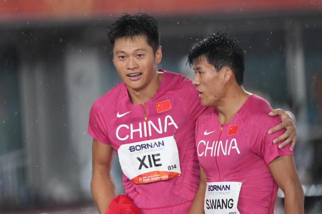 (260928) -- NAGOYA, Sept. 28, 2026 (Xinhua) -- Xie Zhenye (L) and Wang Shengjie of Team China react after the men's 4x100m relay final of athletics at the 20th Asian Games Aichi-Nagoya 2026 in Nagoya, Japan, Sept. 28, 2026. (Xinhua/Luo Yuan)