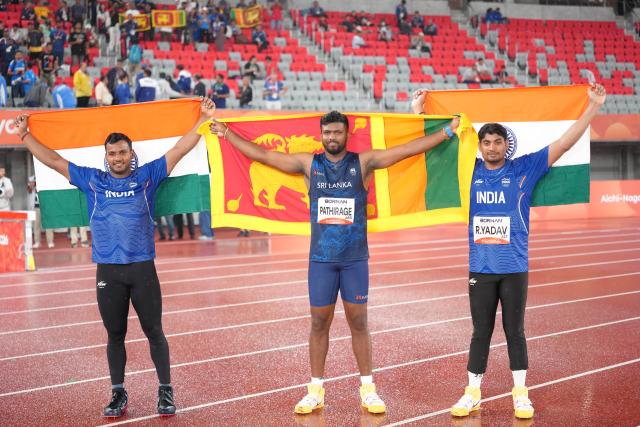 (260928) -- NAGOYA, Sept. 28, 2026 (Xinhua) -- Rumesh Pathirage (C) of Sri Lanka, Yashvir Singh (L) of India, Rohit Yadav of India, pose for photos after the men's javelin throw final of Athletics at the 20th Asian Games Aichi-Nagoya 2026 in Nagoya, Japan, Sept. 28, 2026. (Xinhua/Luo Yuan)