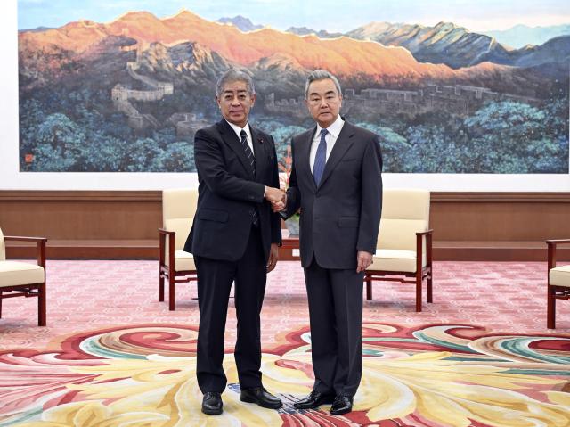 (260928) -- BEIJING, Sept. 28, 2026 (Xinhua) -- Wang Yi, a member of the Political Bureau of the Communist Party of China (CPC) Central Committee and director of the Office of the Foreign Affairs Commission of the CPC Central Committee, meets with Takeshi Iwaya, president of the Japanese Association for the Promotion of International Trade (JAPIT), in Beijing, capital of China, Sept. 28, 2026. (Xinhua/Yin Bogu)