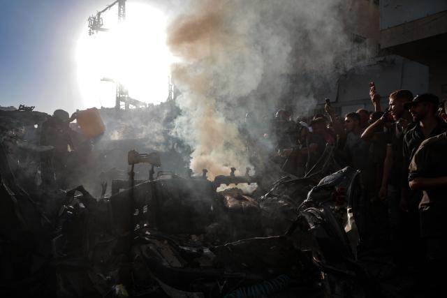 (260928) -- GAZA, Sept. 28, 2026 (Xinhua) -- Palestinians stand around a burned vehicle following an Israeli drone strike in Gaza City, Sept. 27, 2026. (Photo by Rizek Abdeljawad/Xinhua)