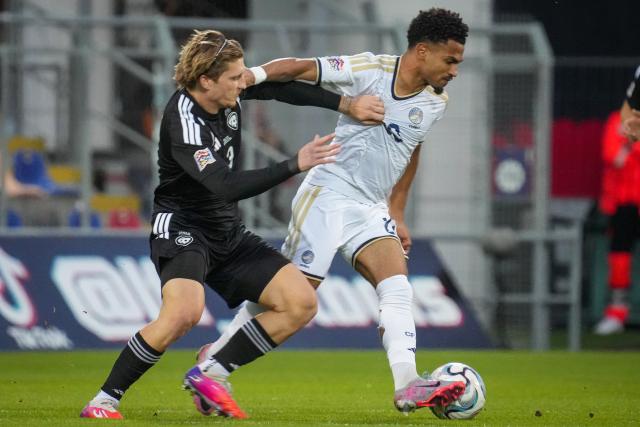 (260929) -- RIGA, Sept. 29, 2026 (Xinhua) -- Latvian player Denniss Cirkins (L) vies with Marcus Edwards of Cyprus during the League C match of UEFA Nations League between Latvia and Cyprus in Riga, Latvia, Sept. 28, 2026. (Photo by Edijs Palens/Xinhua)