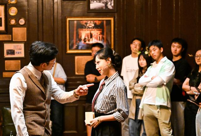 (260929) -- BEIJING, Sept. 29, 2026 (Xinhua) -- Tourists watch an immersive drama at the former site of L'indo Bank of China in Tianjin, north China, Sept. 27, 2026. Built in 1912, the former site of L'indo Bank of China is one of the landmarks in Tianjin's Jiefang North Road historical and cultural block, witnessing the development of the city's financial industry in modern times. 
  This building had undergone many historical changes and had been used successively as an art museum, an international auction house, and a museum of Western art. However, due to the scarcity of exhibitions, it had been idle for a long time until the latest renovation.
  In 2025, Beijing Performance & Arts Group, together with Tianjin North Performing Arts Group, initiated the revitalization of the building, creating an immersive performance scene while preserving its original appearance. (Xinhua/Zhao Zishuo)