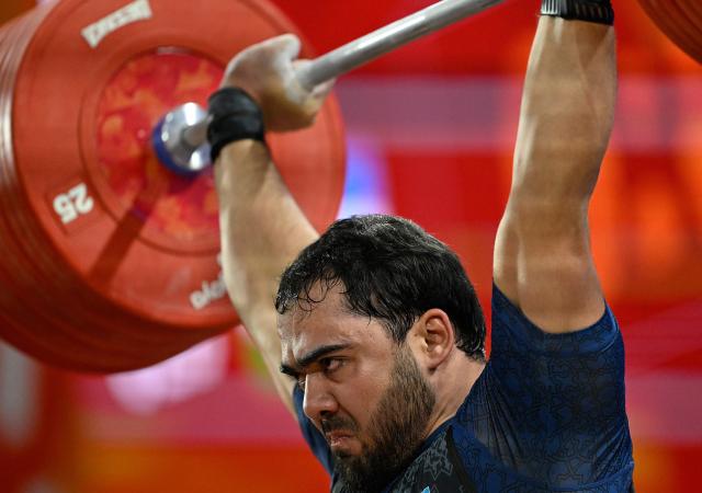 (260929) -- NAGOYA, Sept. 29, 2026 (Xinhua) -- Akbar Djuraev of Uzbekistan competes during the men's 110kg final of weightlifting at the 20th Asian Games Aichi-Nagoya 2026 in Nagoya, Japan, Sept. 29, 2026. (Xinhua/Yu Yang)
