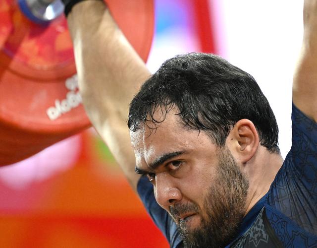 (260929) -- NAGOYA, Sept. 29, 2026 (Xinhua) -- Akbar Djuraev of Uzbekistan competes during the men's 110kg final of weightlifting at the 20th Asian Games Aichi-Nagoya 2026 in Nagoya, Japan, Sept. 29, 2026. (Xinhua/Yu Yang)
