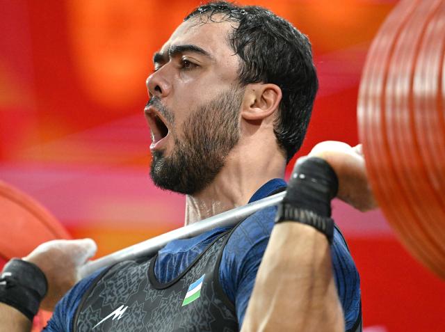 (260929) -- NAGOYA, Sept. 29, 2026 (Xinhua) -- Akbar Djuraev of Uzbekistan competes during the men's 110kg final of weightlifting at the 20th Asian Games Aichi-Nagoya 2026 in Nagoya, Japan, Sept. 29, 2026. (Xinhua/Yu Yang)