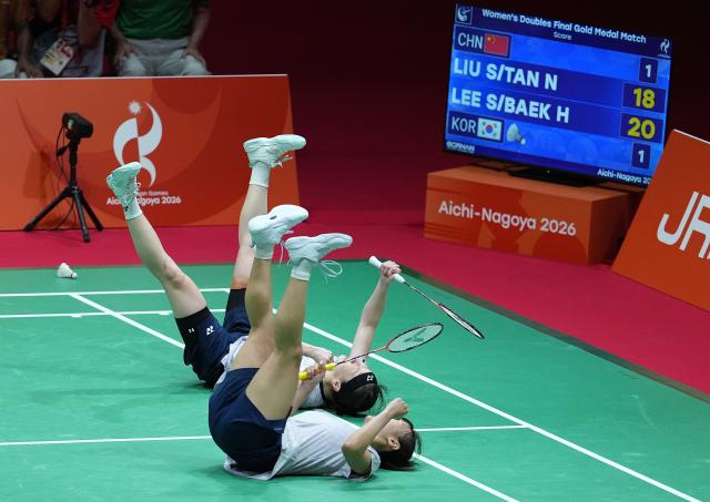 (260929) -- ICHINOMIYA, Sept. 29, 2026 (Xinhua) -- Lee Sohee (top)/Baek Hana of South Korea celebrate after the women's doubles final of badminton against Liu Shengshu/Tan Ning of China at the 20th Asian Games Aichi-Nagoya 2026 in Ichinomiya of Aichi Prefecture, Japan, Sept. 29, 2026. (Xinhua/Cheong Kam Ka)