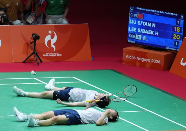 (260929) -- ICHINOMIYA, Sept. 29, 2026 (Xinhua) -- Lee Sohee (top)/Baek Hana of South Korea celebrate after the women's doubles final of badminton against Liu Shengshu/Tan Ning of China at the 20th Asian Games Aichi-Nagoya 2026 in Ichinomiya of Aichi Prefecture, Japan, Sept. 29, 2026. (Xinhua/Cheong Kam Ka)
