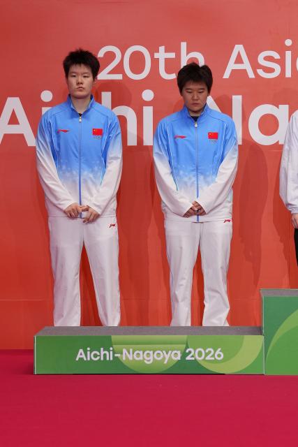 (260929) -- ICHINOMIYA, Sept. 29, 2026 (Xinhua) -- Silver medalists Liu Shengshu (L)/Tan Ning of China react during the victory ceremony for the women's doubles of badminton at the 20th Asian Games Aichi-Nagoya 2026 in Ichinomiya of Aichi Prefecture, Japan, Sept. 29, 2026. (Xinhua/Li Bo)