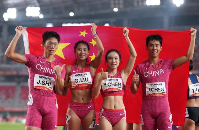 (260929) -- NAGOYA, Sept. 29, 2026 (Xinhua) -- Shi Junhao, Liu Guoyi, Chen Yujie and Chen Jinfeng (L to R) of China celebrate after the 4x100m relay mixed final of athletics at the 20th Asian Games Aichi-Nagoya 2026 in Nagoya, Japan, Sept. 29, 2026. (Xinhua/Lui Siu Wai)