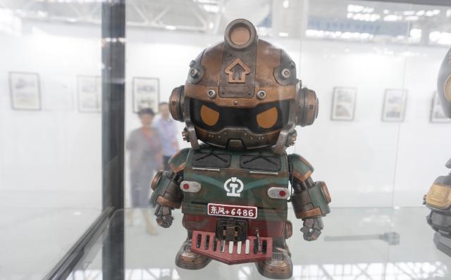 (260929) -- BEIJING, Sept. 29, 2026 (Xinhua) -- A train-themed cultural and creative product is displayed during a railway-themed art exhibition at a CRRC intelligent manufacturing park in Beijing, capital of China, Sept. 29, 2026. A railway culture and art week kicked off in Beijing on Tuesday, with a railway-themed art exhibition displaying over 1,200 exhibits covering painting, sculpture, carving and paper cutting. (Xinhua/Cai Yang)