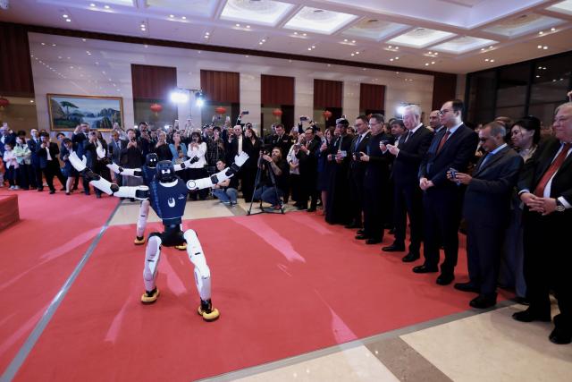 (260929) -- ASTANA, Sept. 29, 2026 (Xinhua) -- Guests watch a robot performance during a reception to celebrate the upcoming 77th anniversary of the founding of the People's Republic of China in Astana, Kazakhstan, Sept. 28, 2026. (Photo by Kalizhan Ospanov/Xinhua)