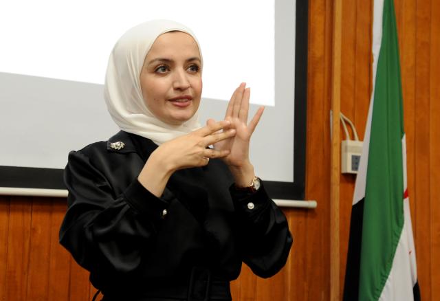 (260929) -- DAMASCUS, Sept. 29, 2026 (Xinhua) -- A woman communicates in sign language during an event marking the International Day of Sign Languages in Damascus, Syria, Sept. 29, 2026. (Photo by Ammar Safarjalani/Xinhua)