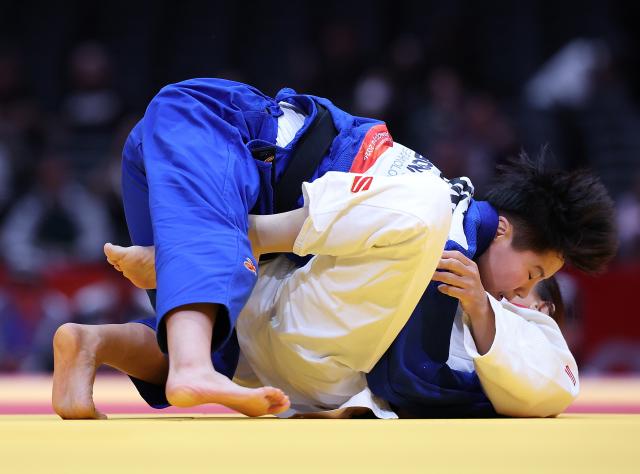 (260930) -- NAGOYA, Sept. 30, 2026 (Xinhua) -- Xu Aoyu (top) of China competes with Tsui Shuk Ki of China's Hong Kong during the Women -52kg Ellimintion Round of 16 match of Judo at the 20th Asian Games Aichi-Nagoya 2026 in Nagoya, Japan, Sept. 30, 2026. (Xinhua/Yao Qilin)
