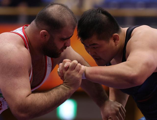 (260930) -- NAGOYA, Sept. 30, 2026 (Xinhua) -- Meng Lingzhe (R) of China competes with Amin Mirzazadeh of Iran during the Men's Greco-Roman 130kg Semifinals of Wrestling at the 20th Asian Games Aichi-Nagoya 2026 in Nagoya, Japan, Sept. 30, 2026. (Xinhua/Li Bo)