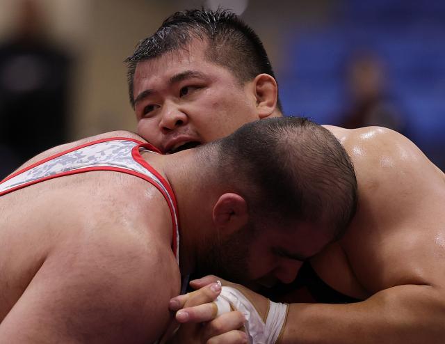 (260930) -- NAGOYA, Sept. 30, 2026 (Xinhua) -- Meng Lingzhe (rear) of China competes with Amin Mirzazadeh of Iran during the Men's Greco-Roman 130kg Semifinals of Wrestling at the 20th Asian Games Aichi-Nagoya 2026 in Nagoya, Japan, Sept. 30, 2026. (Xinhua/Li Bo)