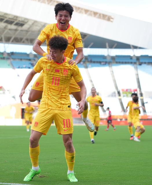 (260930) -- OSAKA, Sept. 30, 2026 (Xinhua) -- Wang Yudong (bottom) of China celebrates his scoring with teammate Xu Bin during the men's semifinals of football between China and South Korea at 20th Asian Games Aichi-Nagoya 2026 in Osaka, Japan, Sept. 30, 2026. (Xinhua/Lui Siu Wai)