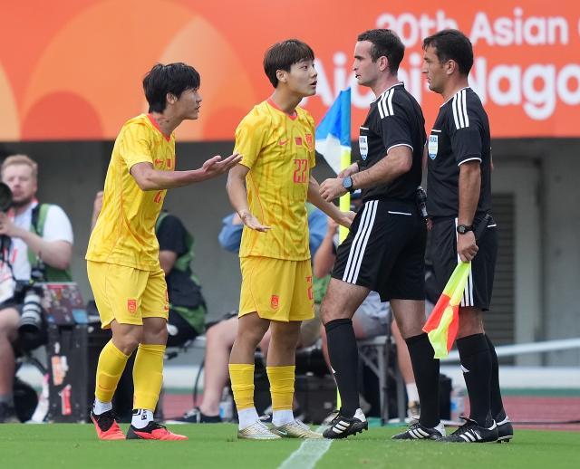 (260930) -- OSAKA, Sept. 30, 2026 (Xinhua) -- Mao Weijie (2nd L) of China communicates with the referee during the men's semifinals of football between China and South Korea at 20th Asian Games Aichi-Nagoya 2026 in Osaka, Japan, Sept. 30, 2026. (Xinhua/Lui Siu Wai)