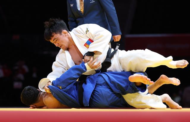 (260930) -- NAGOYA, Sept. 30, 2026 (Xinhua) -- Yolk Kazirbyek (top) of Mongolia competes against Abdurakhim Nutfulloev of Uzbekistan during the Men's -66kg final of Judo at the 20th Asian Games Aichi-Nagoya 2026 in Nagoya, Japan, Sept. 30, 2026. (Xinhua/Yao Qilin)