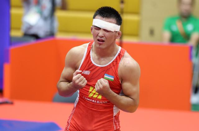 (260930) -- NAGOYA, Sept. 30, 2026 (Xinhua) -- Uzbekistan's Aytjan Khalmakhanov celebrates after winning Japan's Sogabe Kyotaro during the Men's Greco-Roman 67kg finals of Wrestling at the 20th Asian Games Aichi-Nagoya 2026 in Nagoya, Japan, Sept. 30, 2026. (Xinhua/Long Lei)