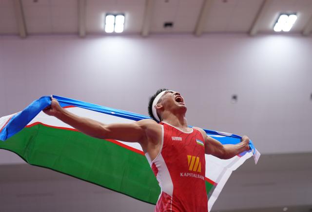(260930) -- NAGOYA, Sept. 30, 2026 (Xinhua) -- Uzbekistan's Aytjan Khalmakhanov celebrates after winning Japan's Sogabe Kyotaro during the Men's Greco-Roman 67kg finals of Wrestling at the 20th Asian Games Aichi-Nagoya 2026 in Nagoya, Japan, Sept. 30, 2026. (Xinhua/Li Bo)