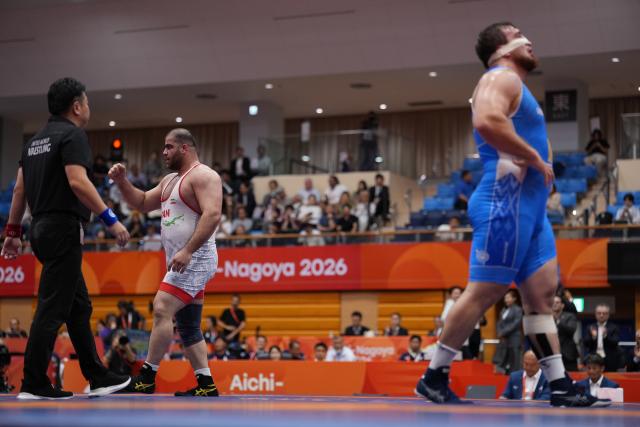 (260930) -- NAGOYA, Sept. 30, 2026 (Xinhua) -- Amin Mirzazadeh (2nd L) of Iran celebrates after winning the men's greco-roman 130kg final of Wrestling against Rafael Tsitsuashvili of Uzbekistan at the 20th Asian Games Aichi-Nagoya 2026 in Nagoya, Japan, Sept. 30, 2026. (Xinhua/Li Bo)