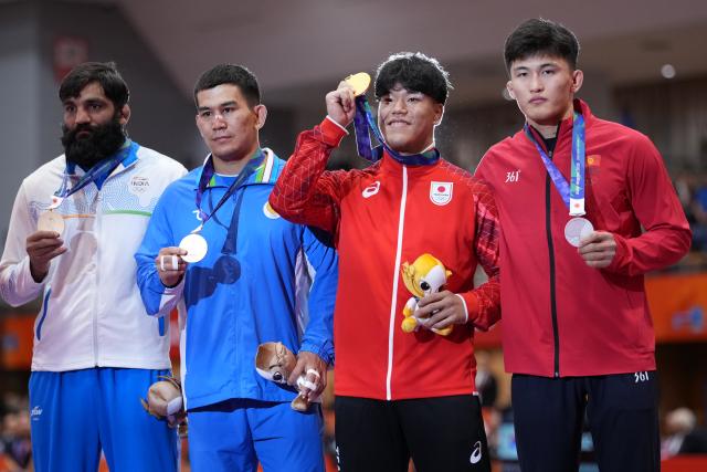 (260930) -- NAGOYA, Sept. 30, 2026 (Xinhua) -- Gold medalist Yoshida Taizo (2nd R) of Japan, silver medalist Asan Kurbanovich Zhanyshov of Kyrgyzstan (1st R), bronze medalists Sunil Kumar (1st L) of India and Jalgasbay Berdimuratov of Uzbekistan pose for photos during the awarding ceremony for the men's greco-roman 87kg final of Wrestling at the 20th Asian Games Aichi-Nagoya 2026 in Nagoya, Japan, Sept. 30, 2026. (Xinhua/Li Bo)