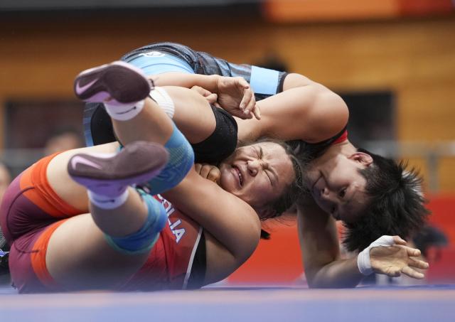 (260930) -- NAGOYA, Sept. 30, 2026 (Xinhua) -- Long Jia (top) of China competes with Mongolia's Delgermaa Enkhsaikhan during the Women's 68kg bronze medal match of Wrestling at the 20th Asian Games Aichi-Nagoya 2026 in Nagoya, Japan, Sept. 30, 2026. (Xinhua/Li Bo)