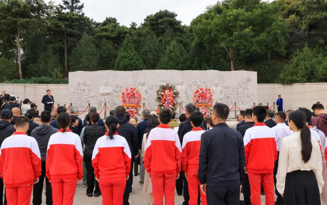 (260930) -- BEIJING, Sept. 30, 2026 (Xinhua) -- People take part in a martyr commemorative event at Xishan National Forest Park in Beijing, capital of China, Sept. 30, 2026. Commemorative events were held across China to mark Martyrs' Day in recent days. Observed on Sept. 30, one day before National Day, the day commemorates those who gave their lives for national independence and prosperity. (Xinhua/Yin Gang)