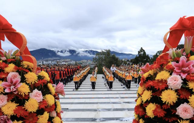 (260930) -- BEIJING, Sept. 30, 2026 (Xinhua) -- Students sing the national anthem during a commemorative event at a martyrs' cemetery in Tengchong City, southwest China's Yunnan Province, Sept. 30, 2026. Commemorative events were held across China to mark Martyrs' Day in recent days. Observed on Sept. 30, one day before National Day, the day commemorates those who gave their lives for national independence and prosperity. (Photo by Gong Zujin/Xinhua)