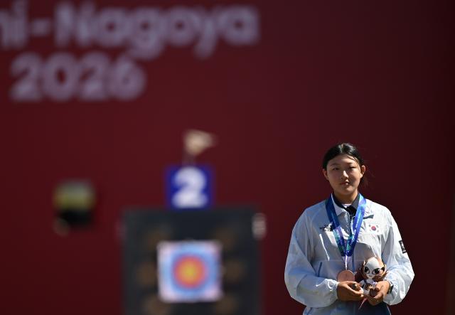 (261001) -- OKAZAKI, Oct. 1, 2026 (Xinhua) -- Bronze medalist Kang Yeonseo of South Korea reacts during the victory ceremony for the compound women's individual of archery at the 20th Asian Games Aichi-Nagoya 2026 in Okazaki of Aichi Prefecture, Japan, Oct. 1, 2026. (Xinhua/Yu Yang)