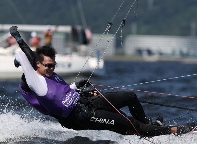 (261001) -- GAMAGORI, Oct. 1, 2026 (Xinhua) -- Liu Tian (front) and Wen Zaiding of China celebrate after the Men's Skiff Opening Series Race of Sailing at the 20th Asian Games Aichi-Nagoya 2026 in Gamagori of Aichi Prefecture, Japan, Oct. 1, 2026. (Xinhua/Deng Hua)