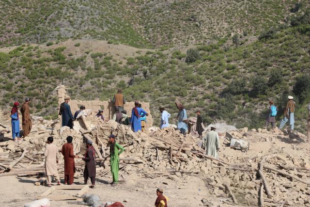 (261001) -- KUNAR, Oct. 1, 2026 (Xinhua) -- This photo taken on Oct. 1, 2026 shows people clearing debris at a village after an airstrike in Kunar province, Afghanistan. Afghan government spokesperson Zabihullah Mujahid said on Thursday that Pakistani airstrikes hit the eastern Afghan province of Kunar early in the day, killing nine people and injuring 11 others, while three houses were also damaged. (Photo by Qazafi Mal/Xinhua)