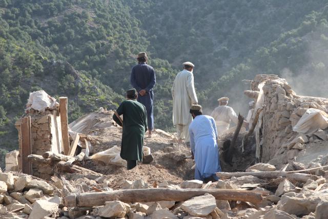 (261001) -- KUNAR, Oct. 1, 2026 (Xinhua) -- This photo taken on Oct. 1, 2026 shows people clearing debris at a village after an airstrike in Kunar province, Afghanistan. Afghan government spokesperson Zabihullah Mujahid said on Thursday that Pakistani airstrikes hit the eastern Afghan province of Kunar early in the day, killing nine people and injuring 11 others, while three houses were also damaged. (Photo by Qazafi Mal/Xinhua)