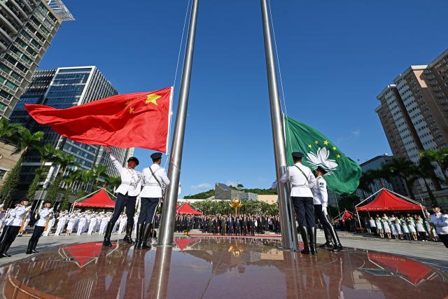 (261001) -- MACAO, Oct. 1, 2026 (Xinhua) -- A flag-raising ceremony marking the 77th anniversary of the founding of the People's Republic of China is held at the Golden Lotus Square in Macao, south China, Oct. 1, 2026. (Xinhua)
