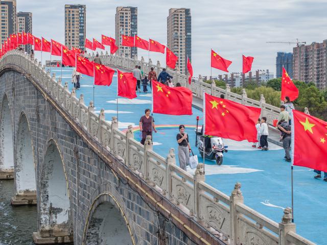 (261001) -- BEIJING, Oct. 1, 2026 (Xinhua) -- A drone photo taken on Oct. 1, 2026 shows people visiting a wetland park in Donghai County, Lianyungang City, east China's Jiangsu Province. People celebrated the 77th anniversary of the founding of the People's Republic of China in various ways on Thursday. (Photo by Shao Guangming/Xinhua)